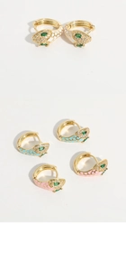 Macro shot of 14k gold-plated snake earrings with zircon pavé and colored enamel inlay