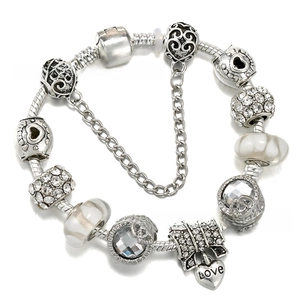 Close-up of silver beaded snake chain bracelet with heart charm and glass beads