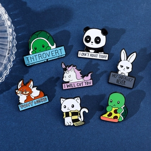 Detailed flat lay of seven cute enamel animal badges with humorous text on blue backdrop