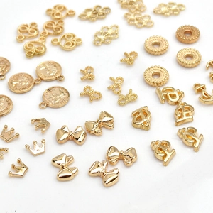 Golden alloy nail art charms featuring crowns, bows and Queen Elizabeth II coins
