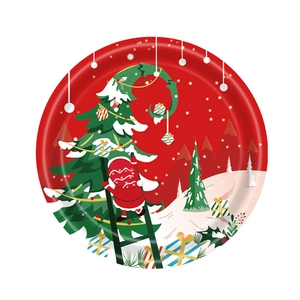 Christmas party paper plate featuring Santa Claus decorating a tree with gifts