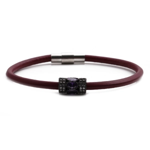 Close-up of handmade burgundy leather bracelet with black beads and crystal stone
