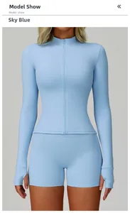 Detail of sky blue long sleeve zipper yoga jacket with thumb holes and matching shorts