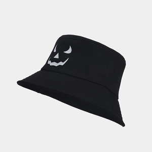Close-up of black cotton bucket hat featuring a white Halloween pumpkin face print