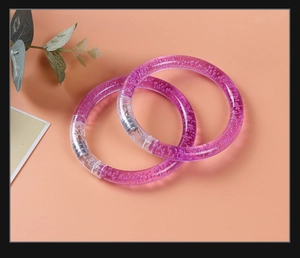 Detail view of two purple LED bubble bracelets made of transparent acrylic material