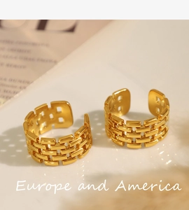 Detail of gold-plated titanium rings with woven brick texture and adjustable open bands