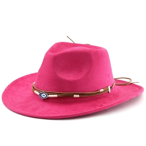 Pink suede fedora hat detail featuring woven brown bands and a Hamsa hand charm