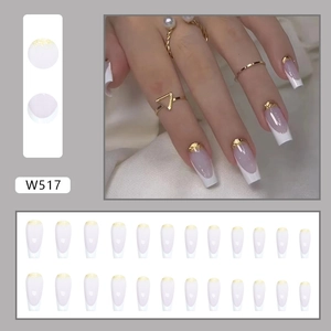 Detail of W517 long coffin press-on nails with white base and gold foil French tips