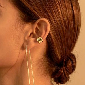 Detailed view of luxury double layer 18k gold plated ear cuff and long chain earrings on model