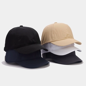 Detail of short brim baseball caps in black, beige, white, and navy breathable fabric
