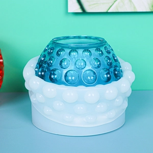 Close-up of a DIY polka dot silicone mold with a blue resin bowl finished product