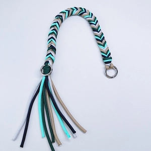Handwoven mint and navy braided shoulder strap with silver ring clasps and stylish tassels