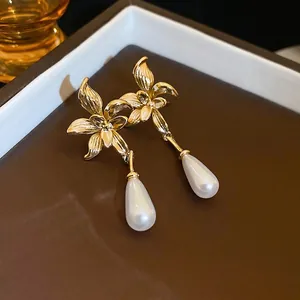 French vintage gold floral drop earrings with white waterdrop pearls and brushed metal finish