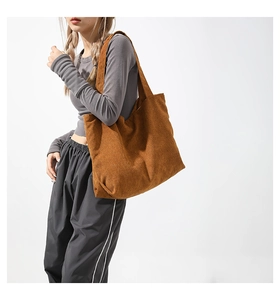 Detailed view of the brown corduroy tote bag showing its rich ribbed texture and large capacity