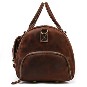 Detail of vintage brown crazy horse leather travel bag with reinforced handles and stitching