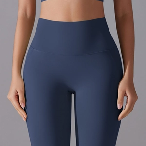 Detail of high-waist navy blue yoga pants showing seamless fabric and ergonomic stitching
