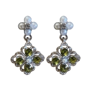 Silver flower drop earrings with olive green gems and pearls on a white background
