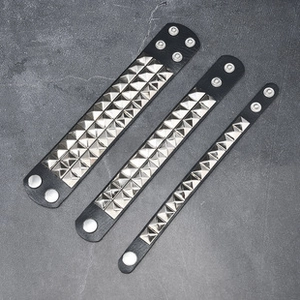Close-up of three punk style black PU leather bracelets with silver pyramid metal studs