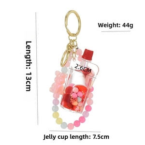 Detail view of acrylic quicksand keychain with pink beads showing dimensions and weight