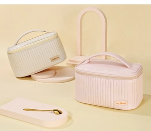 Detail of cream and pink quilted PU leather makeup bags with handle and zip closure