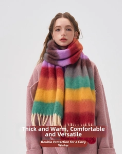 Close-up of colorful striped knit scarf with decorative tassels and thick warm texture
