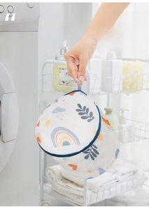 Detail of cylindrical laundry bag with leaf prints and a convenient carrying handle