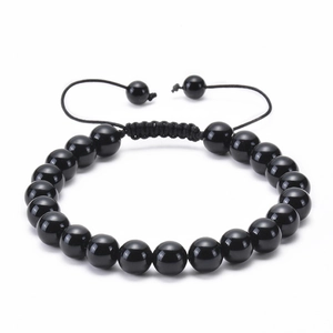 Detail of adjustable braided cord closure on a black natural stone beaded bracelet
