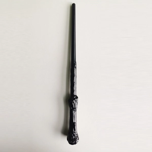 Detail of a glowing wizard wand with a spiral handle design for Halloween cosplay