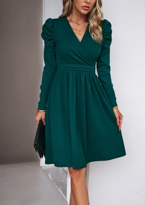 Detail of elegant V-neck dark green long sleeve dress with slim waist design on model