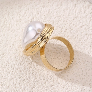 Close-up of baroque irregular pearl on a textured gold-plated adjustable ring band