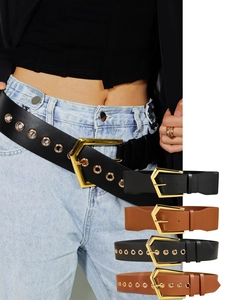 Close-up of wide elastic belts in black and brown with gold geometric buckles