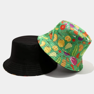 Reversible cotton bucket hat featuring solid black side and colorful vegetable print