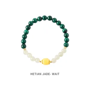 Macro view of green malachite textured beads and Hetian jade on beaded bracelet