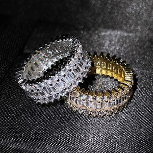 Elegant gold and silver eternity rings set with emerald and round cut cubic zirconia