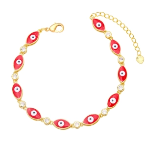 Detail of gold evil eye bracelet featuring red drip oil enamel and zircon accents