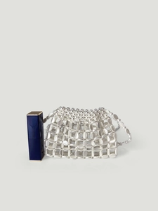 Close-up of silver beaded mini handbag with lipstick for size reference