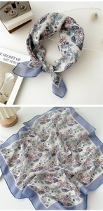 Detailed view of floral cotton linen neckerchief with daisy prints and blue borders