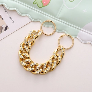 Detail of gold-plated Cuban chain with rhinestones for shoe charms and bags