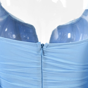 Detail view of the back of a blue mesh dress featuring ruched fabric and hidden zipper