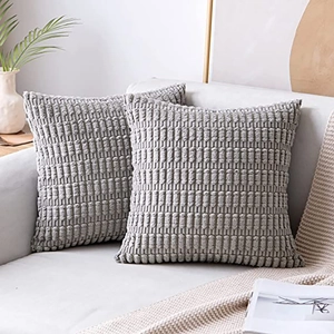 Detailed texture of gray corduroy pillow covers showing ribbed fabric on a sofa