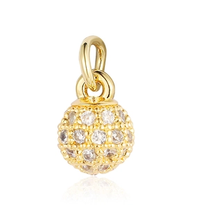 Close-up of a golden spherical charm set with clear zircons for DIY jewelry design