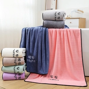 Detail of coral fleece towels with morning night print and black stitched edges