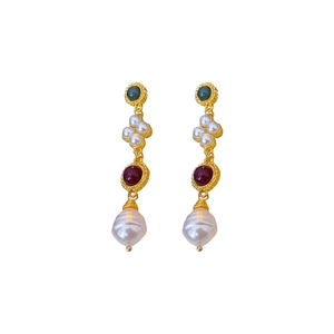 Vintage gold earrings with green and red stones and baroque pearls on white background
