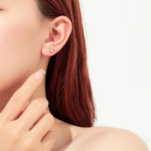 Close-up of model wearing elegant 925 silver stud earrings with multi-colored zircon stones
