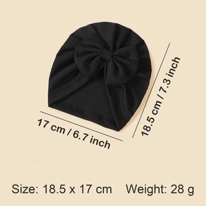 Detail view of black ribbed knit baby hat with dimensions 18.5 x 17 cm and large bow