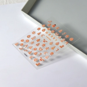 3D Christmas nail stickers with metallic rose gold gingerbread and reindeer designs