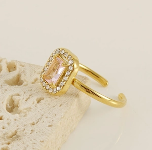 Detail of pink rectangular zircon ring with 18K gold plating and diamond accents