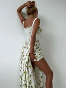 Detail of white floral sundress showing yellow lemon print and high side leg slit
