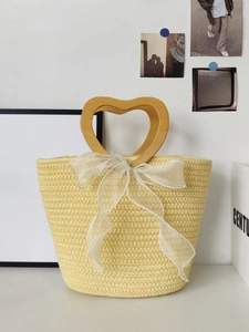 Sweet yellow woven heart-handle tote bag with large white ribbon bow for gift