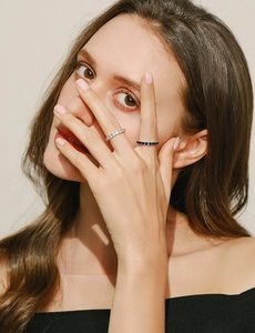 Close-up of elegant S925 silver rings with white and blue sparkling diamonds on model